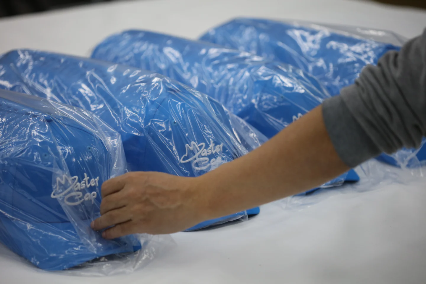 Finished custom caps being bagged and packed for shipment