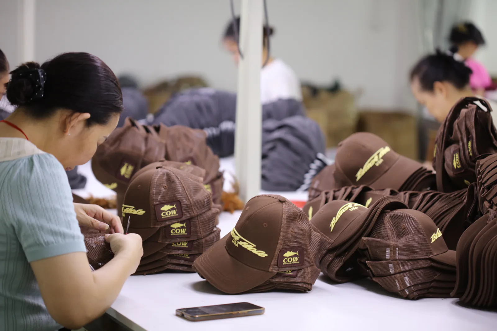 MasterCap team checking finished cap components during production