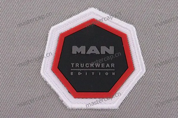 MHP011 Injection-molded PVC embossed twill patch appliqué with satin-stitch edging