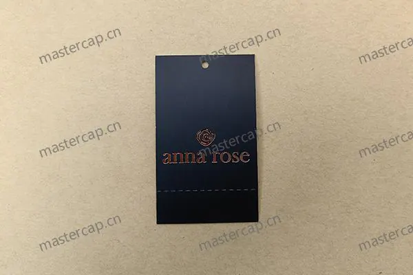 MHT030 400 gsm perforated art paper hangtag with single-sided printing, gloss lamination and rose-gold foil stamping