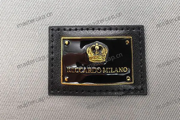 MB001 Imitation-gold-plated metal patch with soft enamel and leather backing