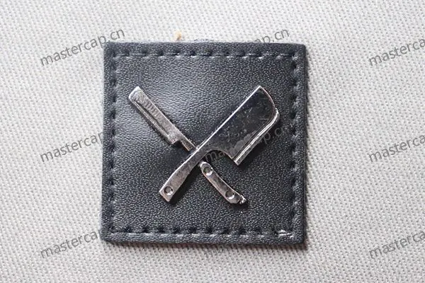 MB006 Black-nickel-plated metal patch with leather backing