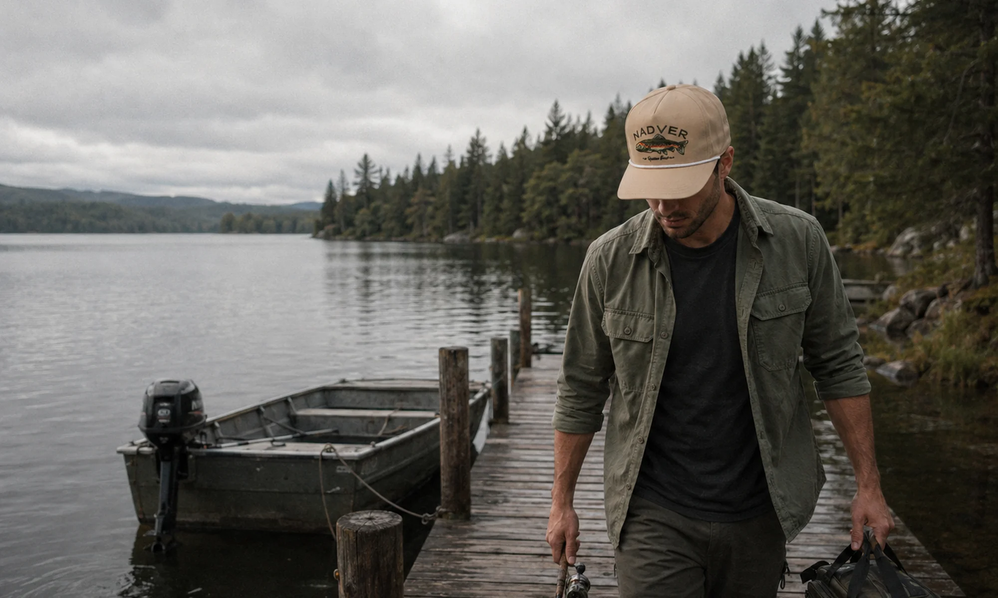 Angler wearing a custom fishing cap beside a dock