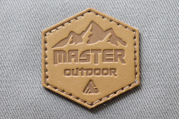 Embossed badge for custom caps