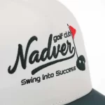 Green and red flat embroidery on ivory golf cap front panel