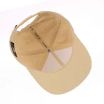 Fishing cap interior with textured performance sweatband and branded seam tape