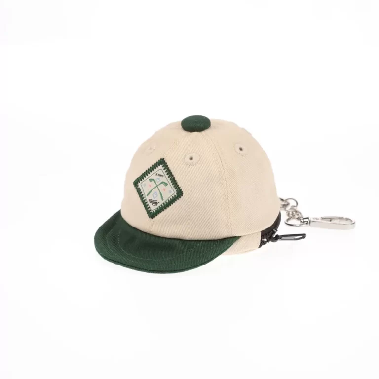 Beige and dark-green mini cap bag keychain with golf patch, front angle