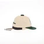 Opposite side view of beige and dark-green mini cap bag keychain