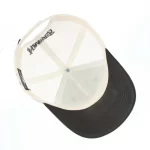 Interior view of six-panel trucker cap with mesh back and curved visor