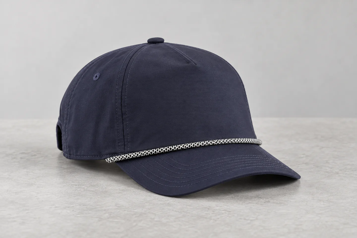 Navy five-panel rope cap showing structured crown, curved visor and contrast rope detail.