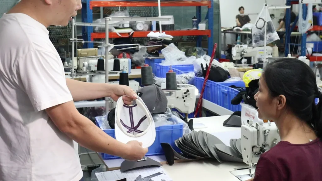 MasterCap team reviewing a physical custom cap sample during product development